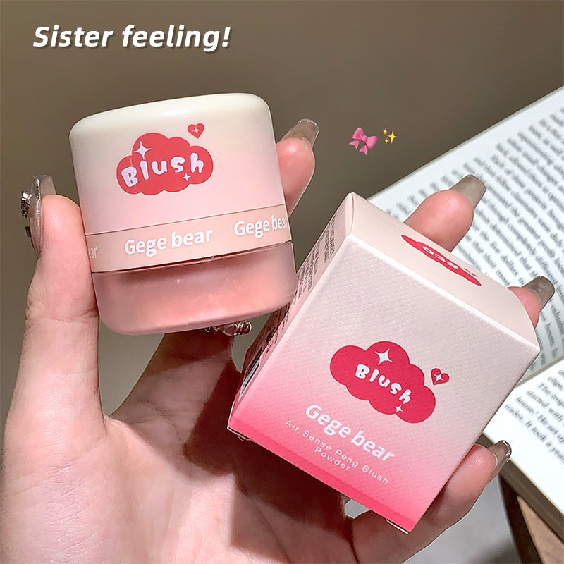 Pink blush product with packaging held in a hand, labeled 'Gege bear Blush'.