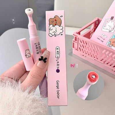 Pink cleaning brush with packaging and additional accessories on a light gray background