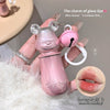 Pink bear-shaped glass with lip charm held by a hand, close-up of lips inset.