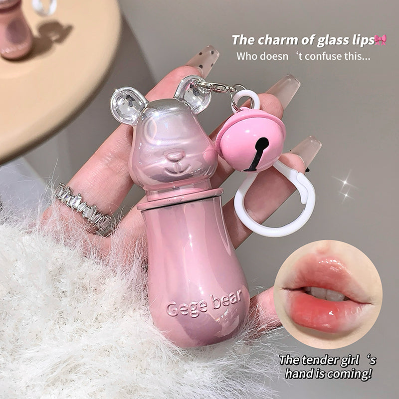 Pink bear-shaped glass with lip charm held by a hand, close-up of lips inset.