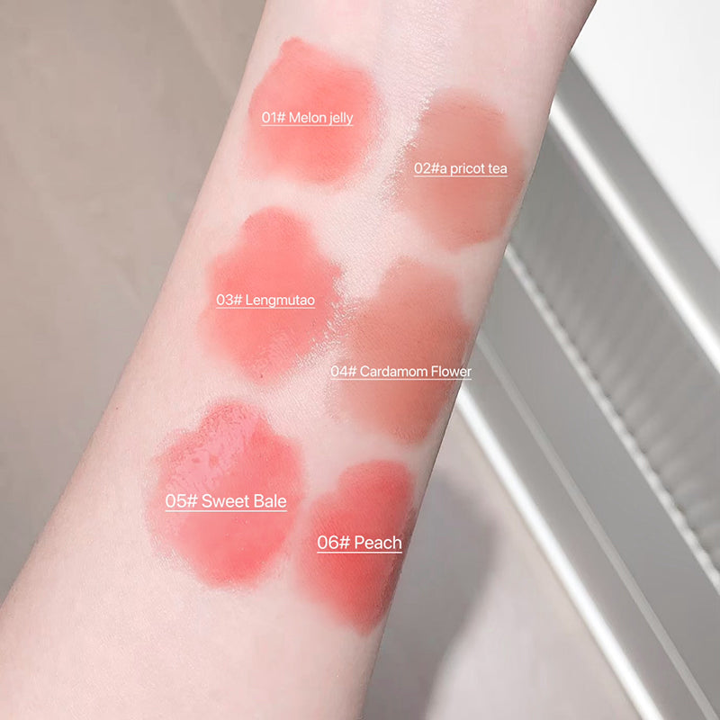 Lipstick swatches on a person's arm with color names labeled