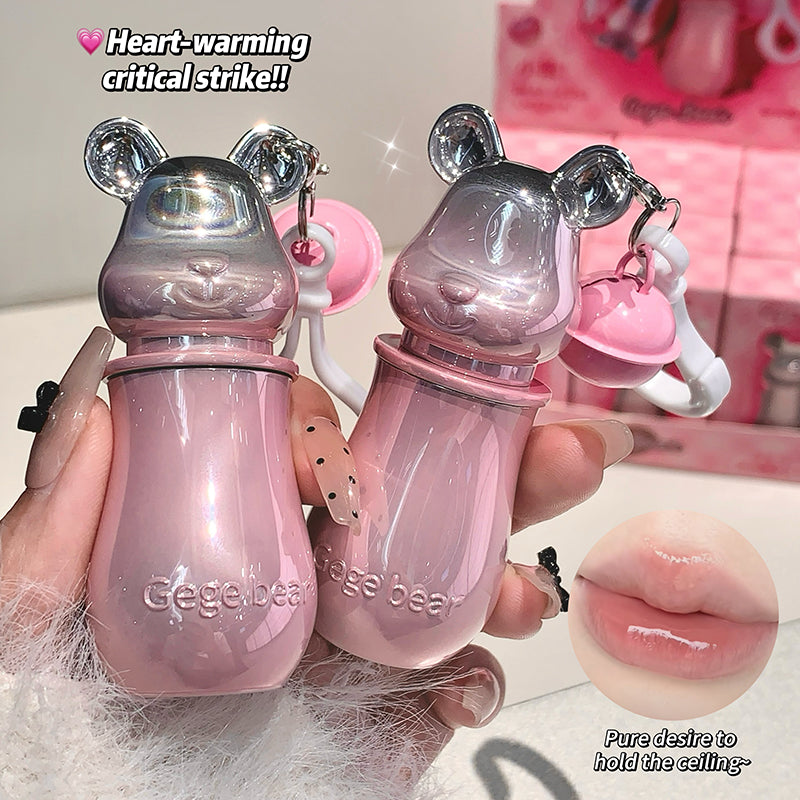 Pink bear-shaped bottles held by a hand with a blurred background