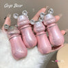 Pink bear-shaped containers with 'Gege Bear' branding held in a hand.