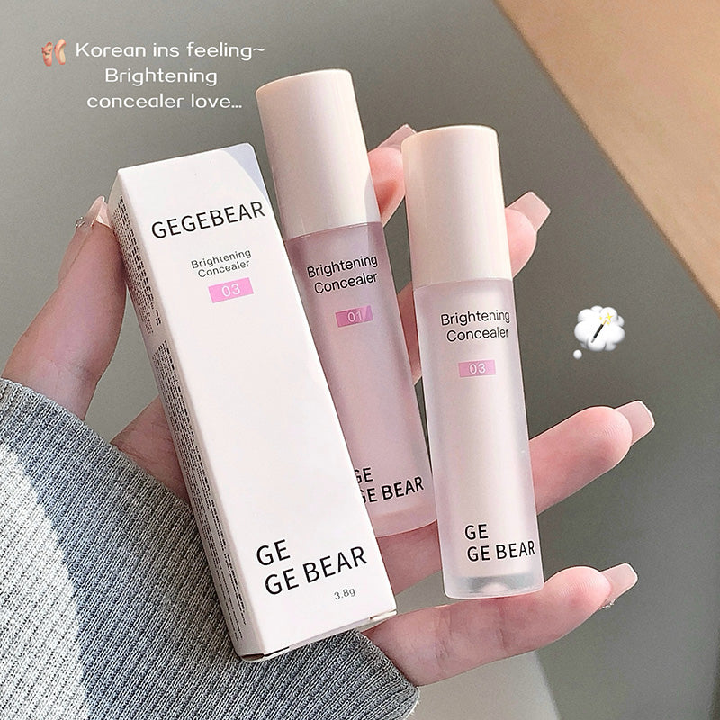 Three GEGBEAR brightening concealers held in a hand against a neutral background