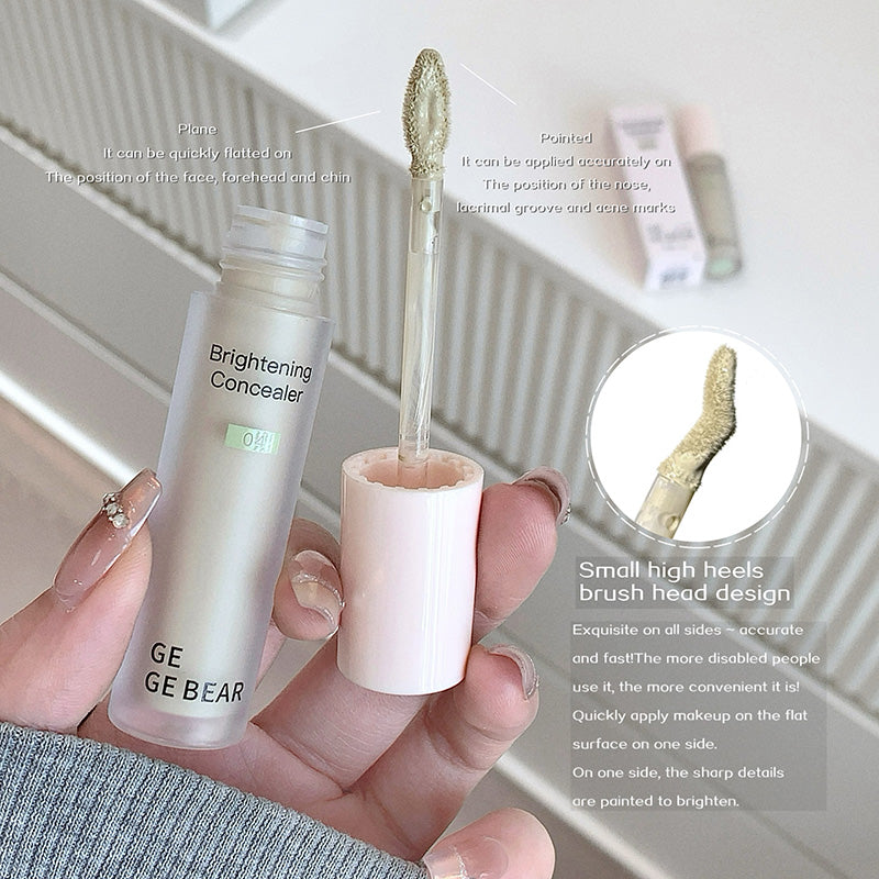 Hand holding a GE GE BEAR brightening concealer with brush and text on a white background