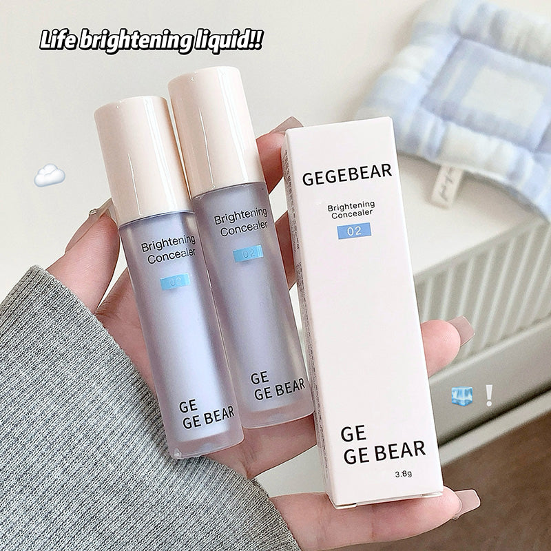 Two GE GE BEAR brightening concealers and a box held in a hand with a light background.