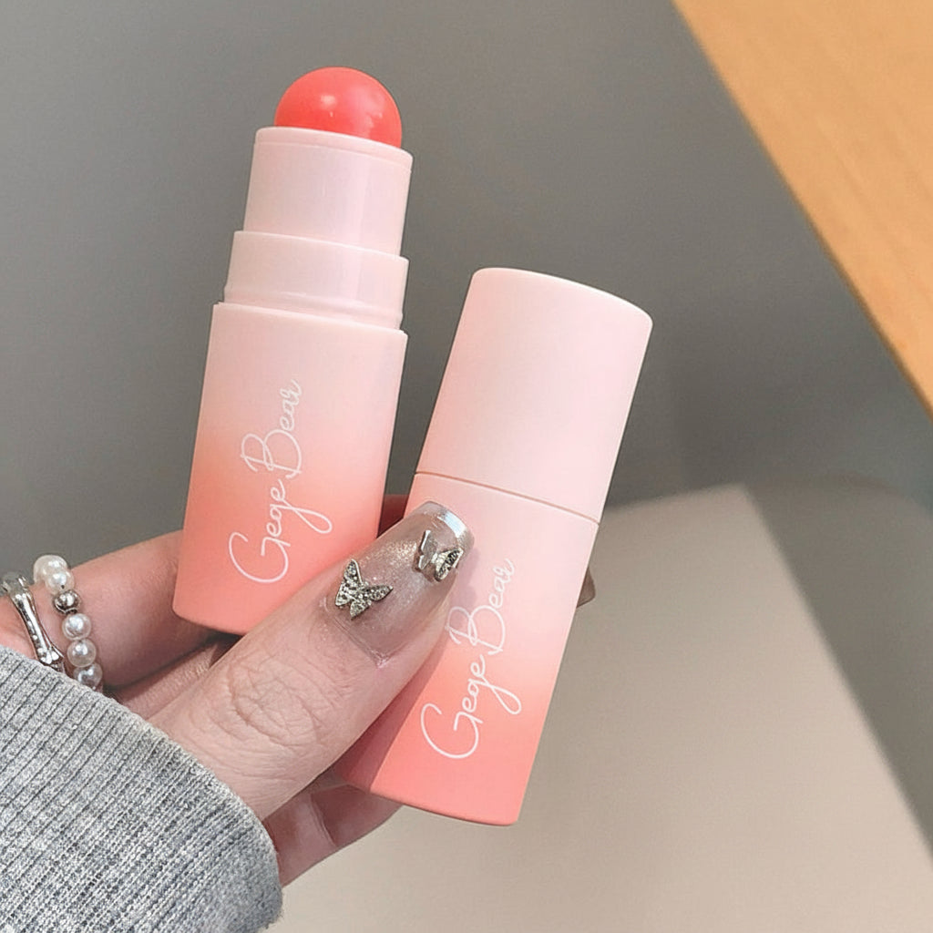 Two pink lip balms with a hand holding them, and an inset of a person wearing pink lipstick.