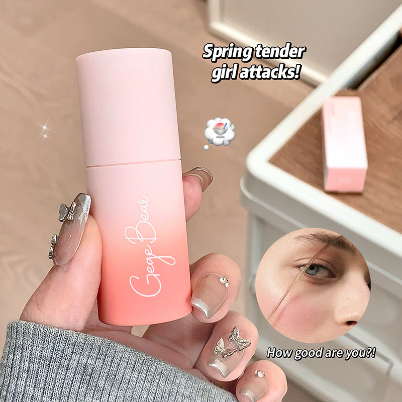 Pink and orange lip balm with 'Bear Bear' branding, held by a hand with decorative nails.