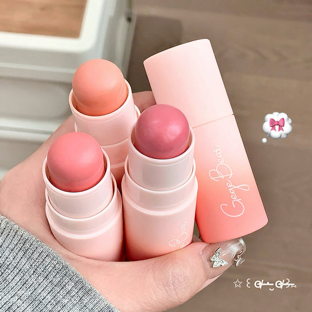 Hand holding pink lip balms with visible brand name, text 'The milk is so cute!'