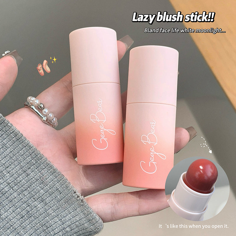 Two gradient blush sticks held by a hand with a blurred background