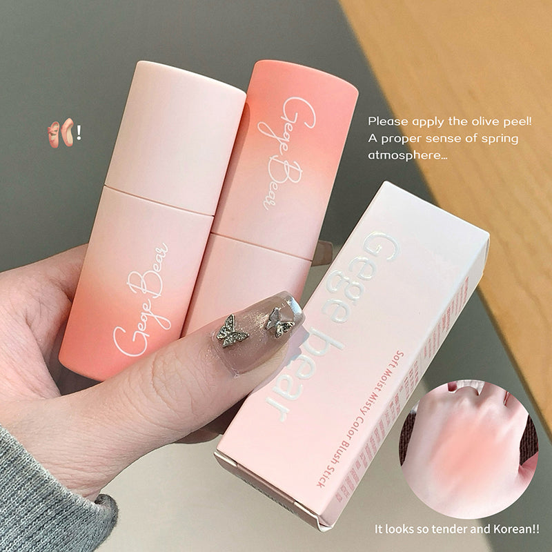 Two gradient lip balms and their packaging held by a hand on a neutral background.