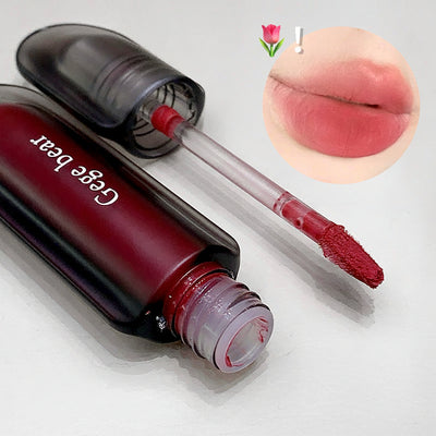 Lip puree with applicator and close-up of lips wearing the product on a light gray background