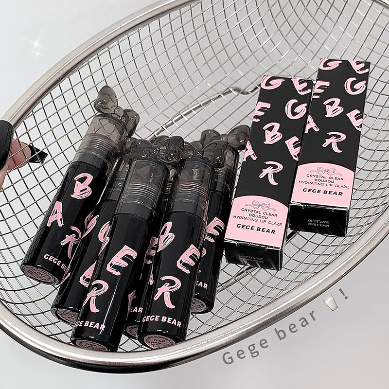 Gege Bear lip products including lip glosses and packaging on a metal surface.