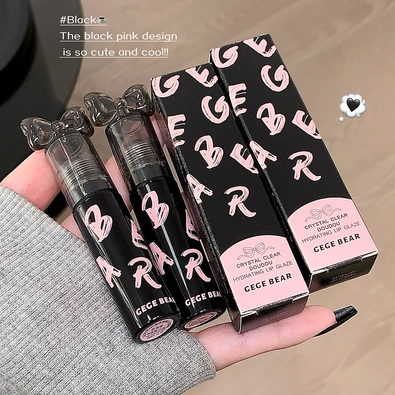 Lip gloss with black and pink design held by a hand, showing 'GEGE BEAR' branding.