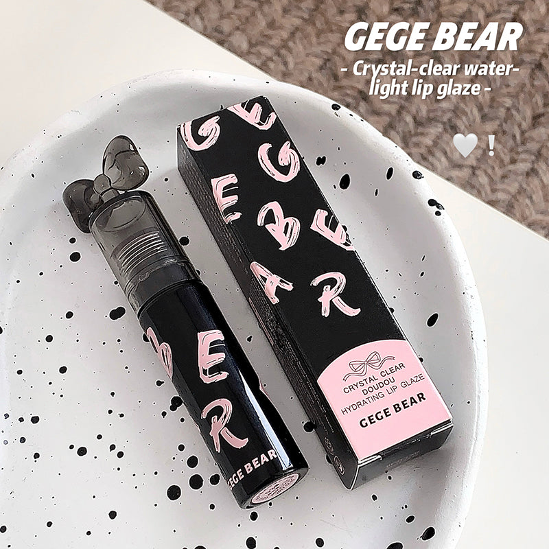 CEGE BEAR lip gloss with packaging on a speckled white plate
