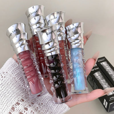 Hand holding four GEGE BEAR water light mirror lip balms with visible text and branding.