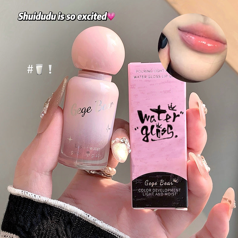 Hand holding a pink lip gloss with packaging, showing a close-up of lips with the product applied.