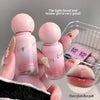 Two small pink bottles labeled 'Gege Bear' held by a hand with a blurred background.