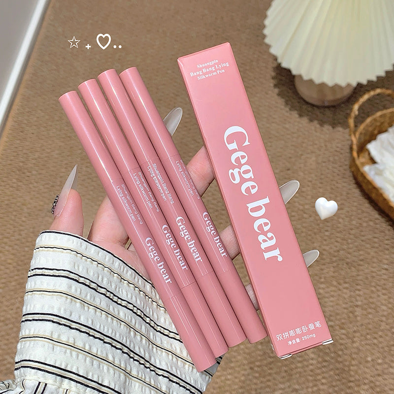 Pink lip liner pencils with 'Gege bear' packaging held by a hand on a wooden surface.