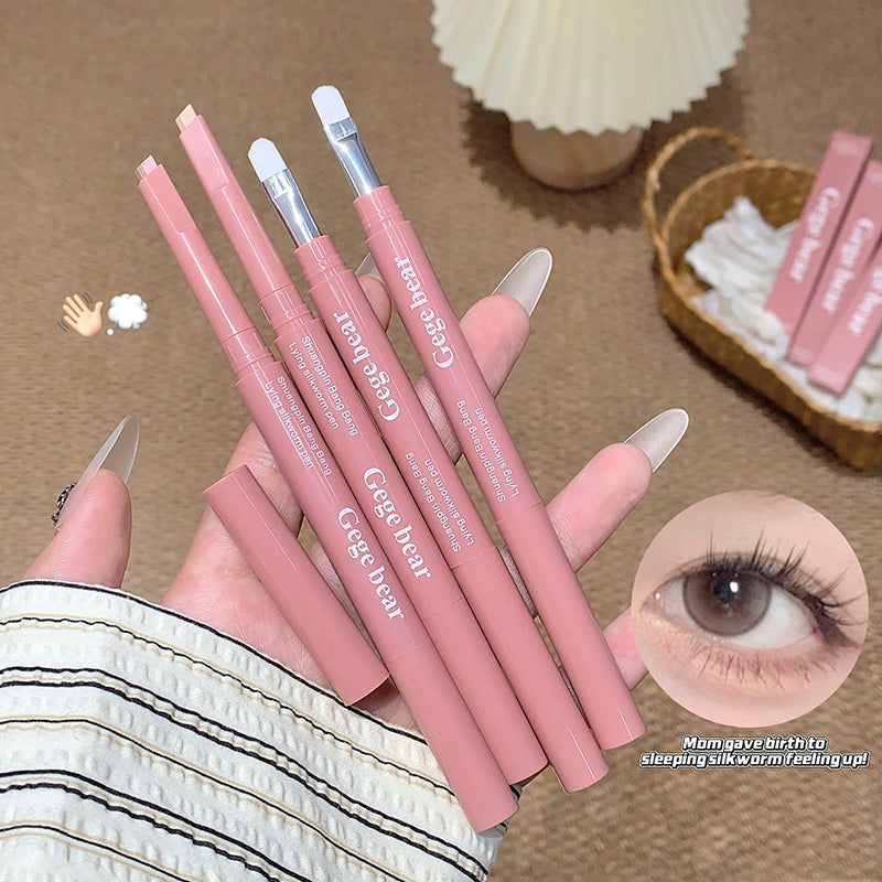 Pink eyeliner pencils with silver tips held by a hand, with an eye close-up in the corner.