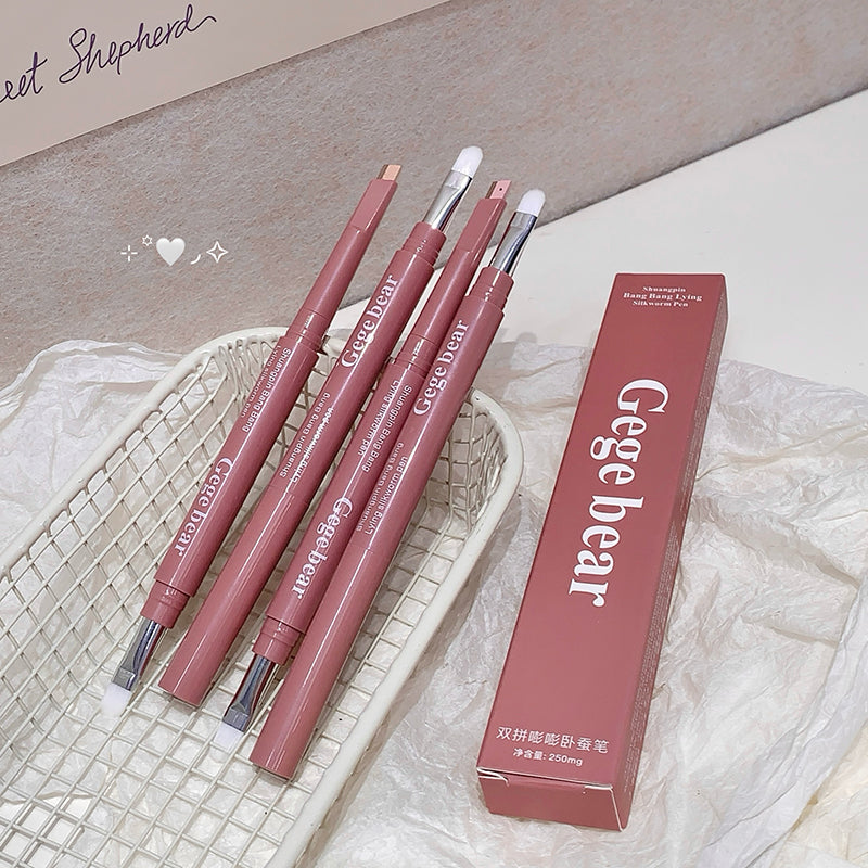 Set of Gege bear makeup brushes with their packaging on a textured surface