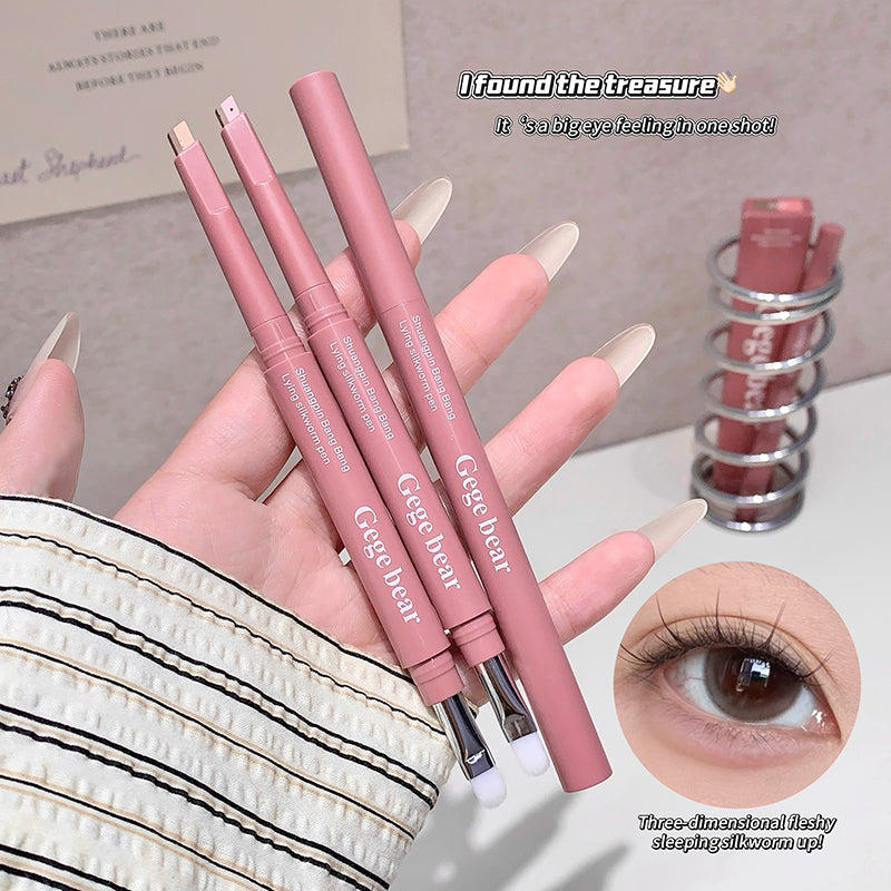 Pink makeup brushes held by a hand with an inset of an eye wearing the product.