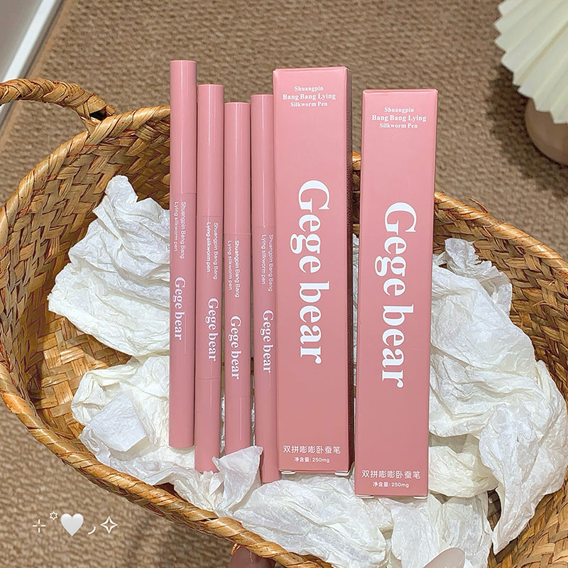 Pink eyeliner pencils and packaging with 'Gege bear' branding on a woven tray.