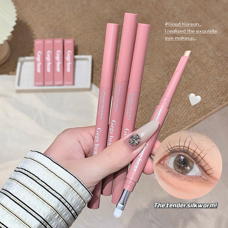 Pink eyeliner pencils held by a hand with a close-up of an eye wearing the product.