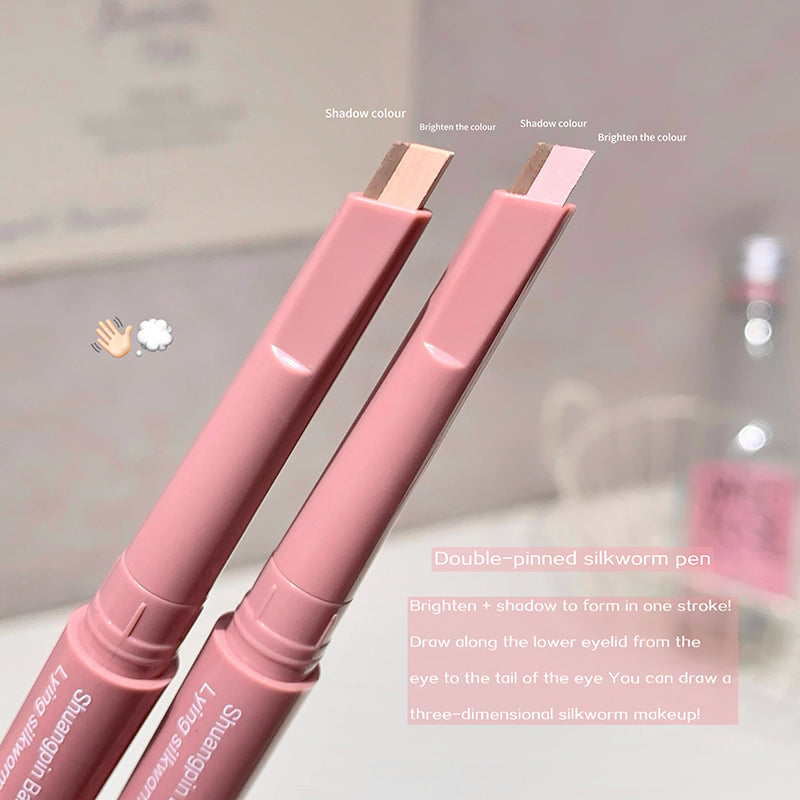 Two pink makeup pens with text on a blurred background