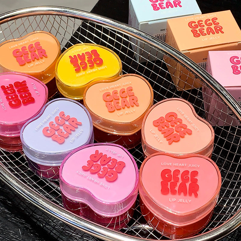 Heart-shaped lip jelly containers with 'GEGE BEAR' branding on a metal tray.