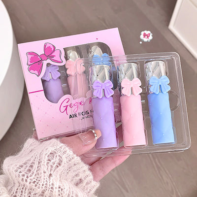 Set of pastel-colored air fresheners with decorative bows in a clear plastic case, held by a person.