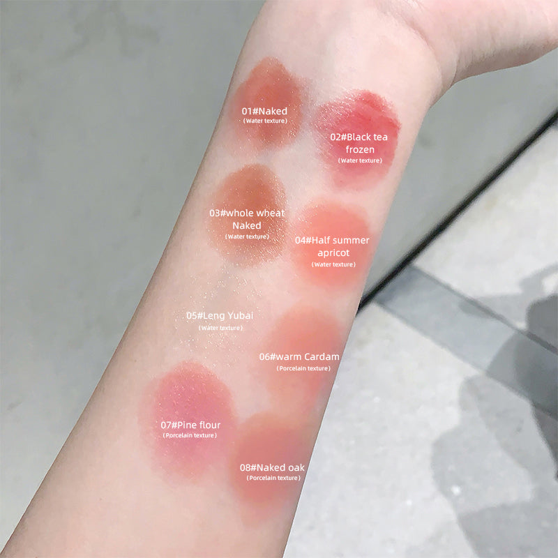 Lipstick swatches on a person's arm with labeled colors.