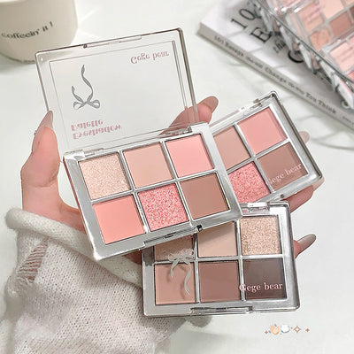Makeup palette with 'Gege bear' branding held by a hand on a light background.