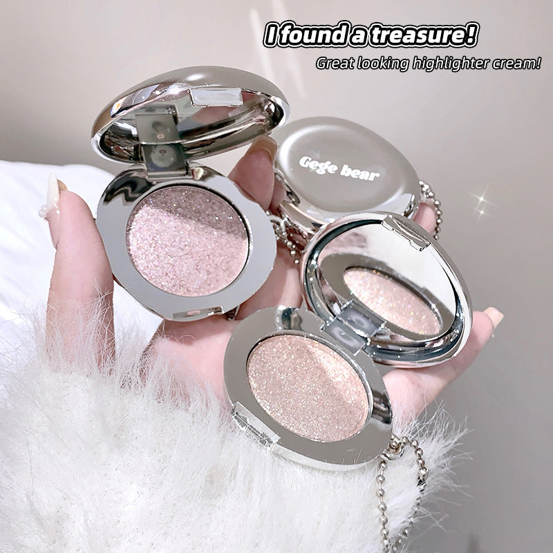 Highlighter cream in a compact case held by a hand, with 'Geege bear' branding.