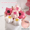 Pink and white lip masks with 'Gege bear' branding held by a hand.