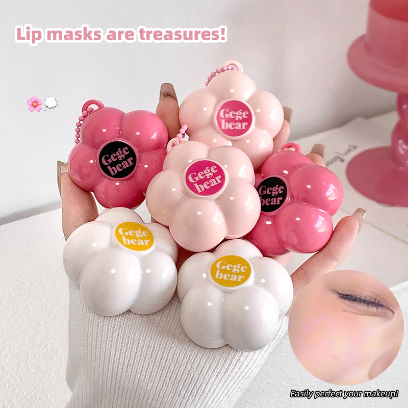 Pink and white lip masks with 'Gege bear' branding held by a hand.