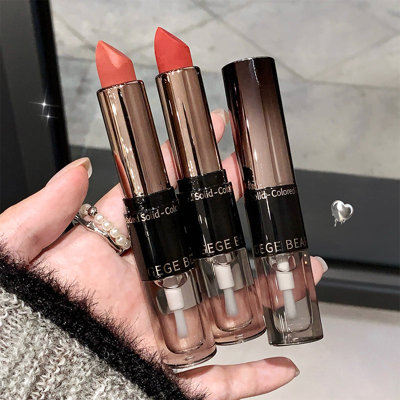 Three lipsticks held in a hand with a blurred background