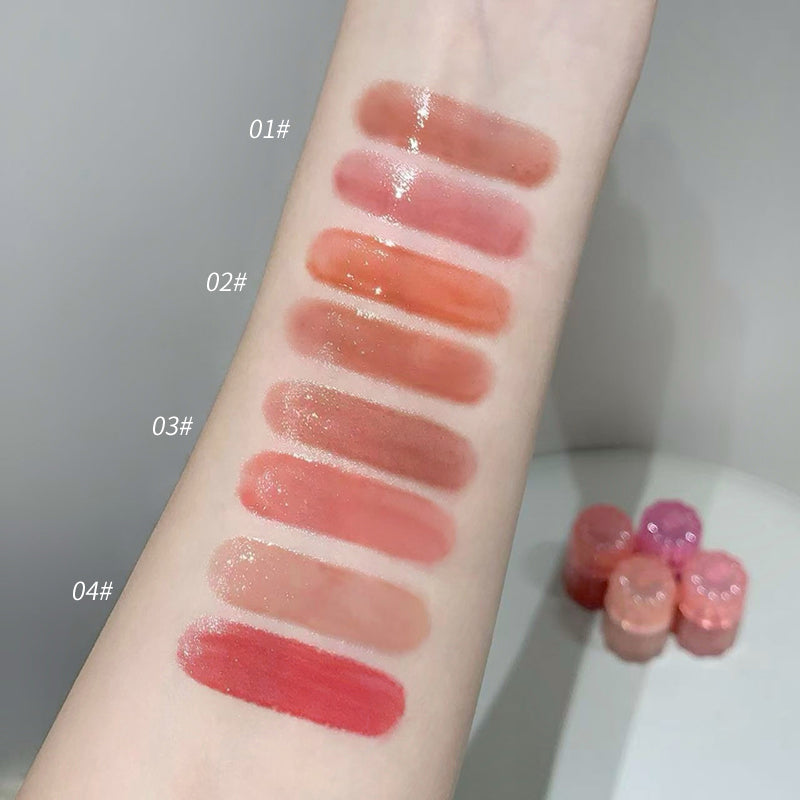 Lipstick swatches on a person's arm with labeled colors and small lipsticks beside.