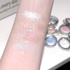 Glittery makeup product swatched on a arm with a palette in the background