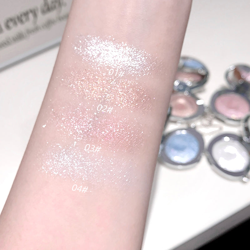 Glittery makeup product swatched on a arm with a palette in the background