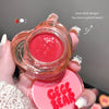 Pink lip balm with a clear cap held by a hand, branded 'GEGE BEAR'.