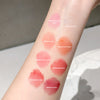 Lipstick swatches on a person's arm with labeled colors