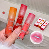 Three lip oil bottles held in a hand with a close-up of lips wearing the product and strawberry illustration.