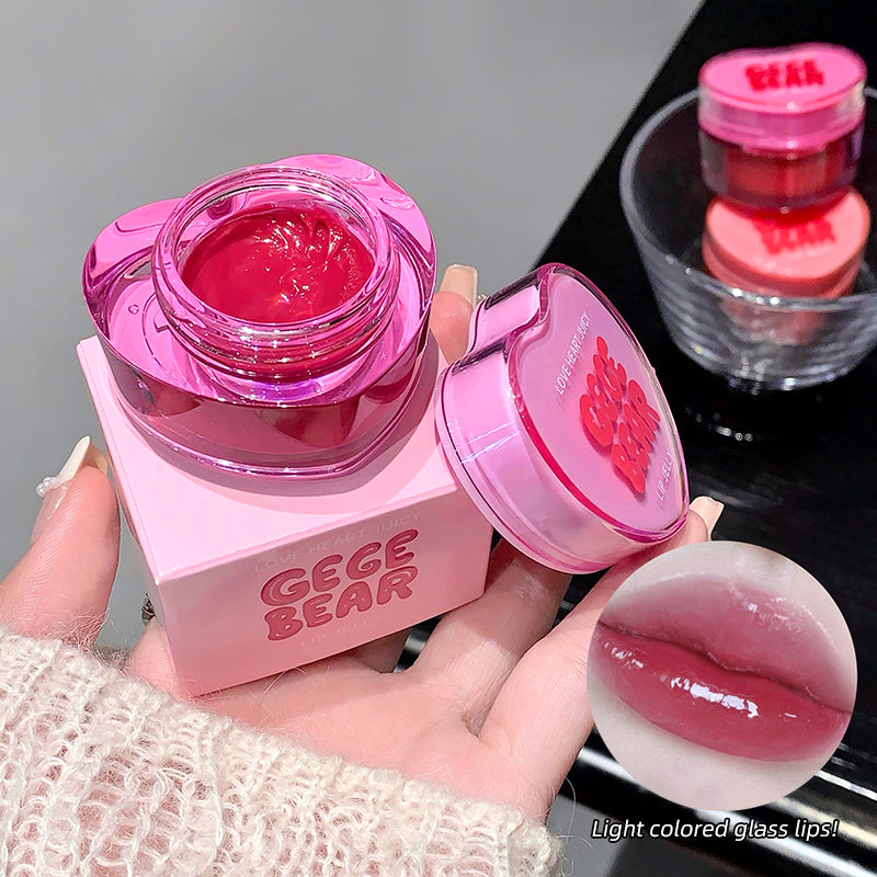 Pink lip balm container with 'GEGE BEAR' branding, held by a hand.