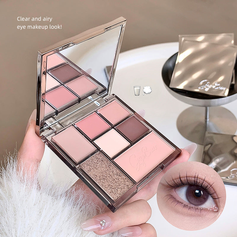 Makeup palette with eyeshadows and a close-up of an eye with makeup, on a neutral background.