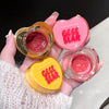 Hand holding three heart-shaped lip jelly products with 'Geege Bear' branding.