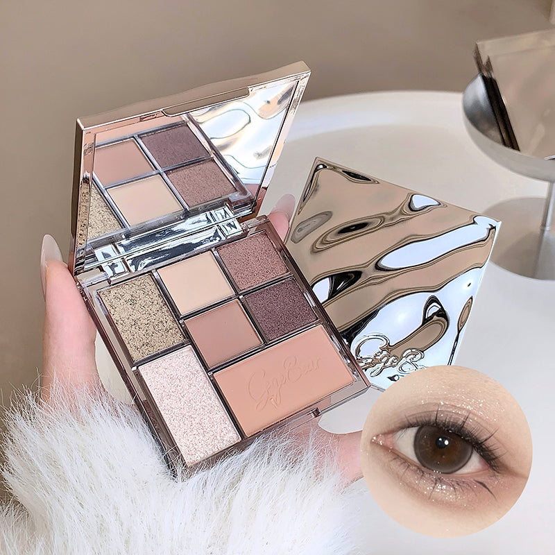 Makeup palette with eyeshadows and a close-up of an eye wearing the makeup.
