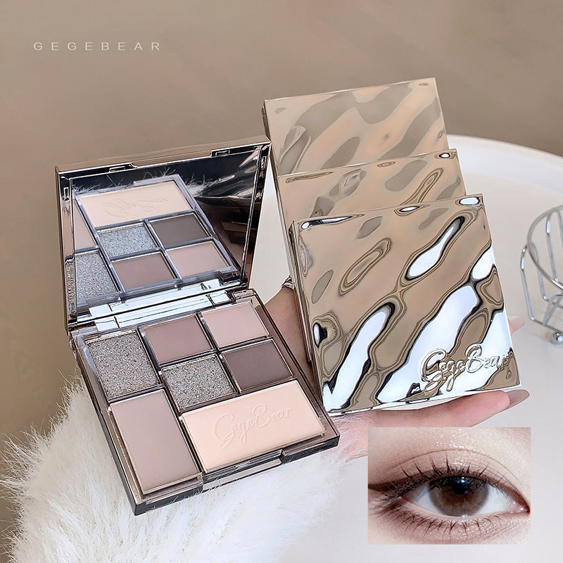 Makeup palette with a mirror and a close-up of an eye wearing the makeup.