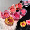 Hand holding multiple small jars of pink lip gloss with 'Geece Bear' branding.