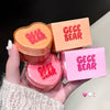 GEGE BEAR lip jelly with packaging held by a hand on a neutral background